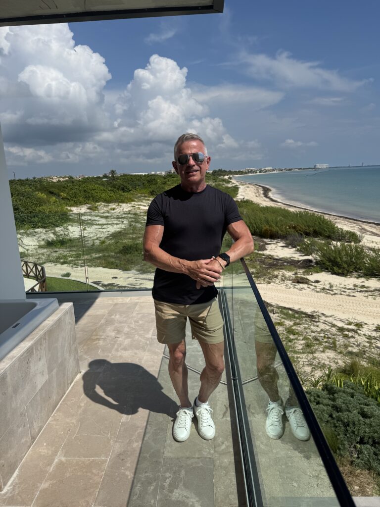 Mark Cepaitis, founder and travel advisor at Journeys by Mark, standing by the ocean